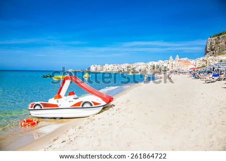 CEFALU,SICILY-SEP 16,2014: Unidentified people on sandy beach in Cefalu, Sicily, Italy at Sep 16, 2014. Cefalu is an attractive historic town and seaside resort.
