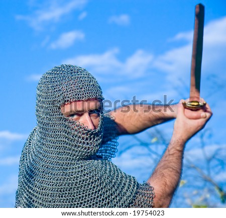 Knight warrior wearing armour and hold on a sword