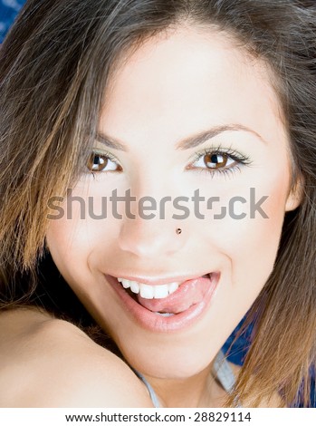 young sexy woman touch her up lip  by tongue, close up