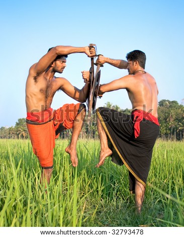 Kalarippayat,two warriors with swords and shields, indian ancient martial art of Kerala, India