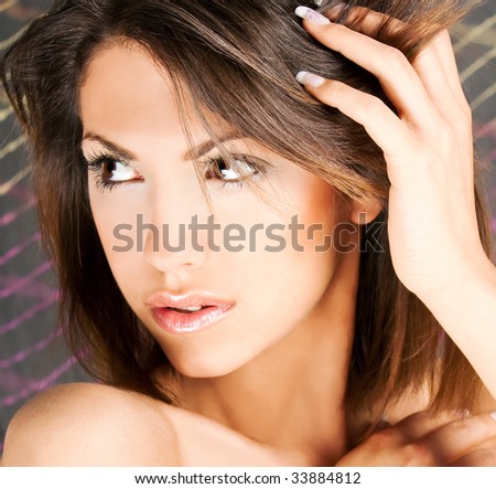portrait of a cute brunette with brown eyes , studio shot