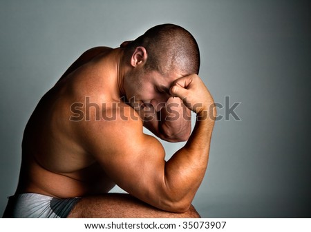 A perfect muscular man posing artistic, studio shot