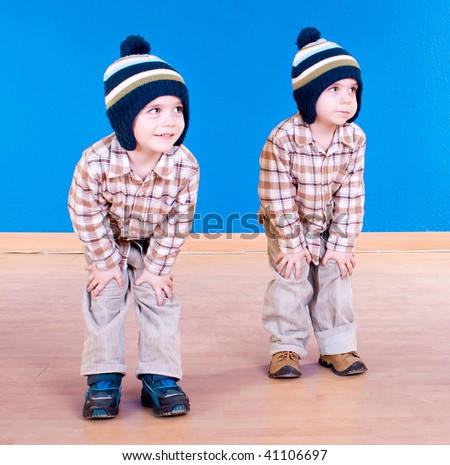 Twins brother  have fun playing, studio shot