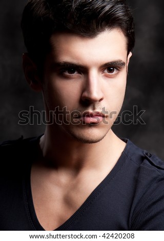 Close up Fashion Shot of a Young Man. A trendy European man dressed in contemporary cloth. He is now a professional model.