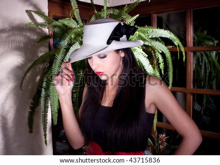 Photo-session of the young beautiful  woman with white hat