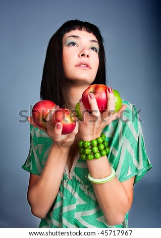 Young brunette seductive woman  holding an apple. Natural beauty artistic portrait.