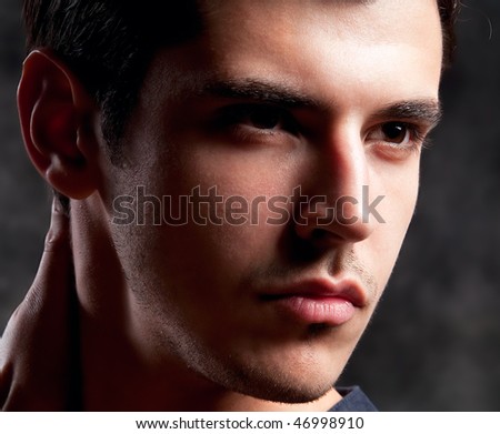 Close up Shot of a macho Man. A trendy European man dressed in contemporary cloth. He is now a professional model.