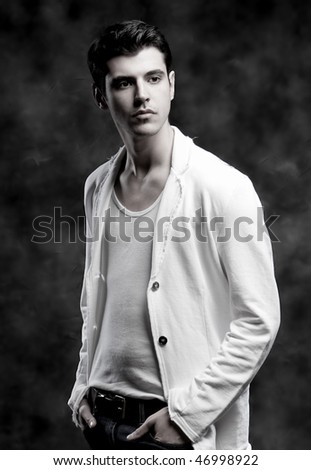 Black and white Shot of a macho Man. A trendy European man dressed in contemporary cloth. He is now a professional model.