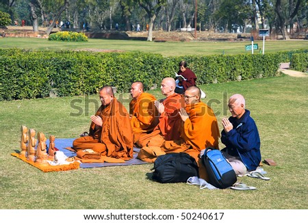 SARNATH, INDIA -14 FEBRUARY: Buddhist monks sitting in meditation pose and pray, tibetan buddhist monastery in Sarnath, Uttar Pradesh, February 14, 2008.  Sarnath, India.