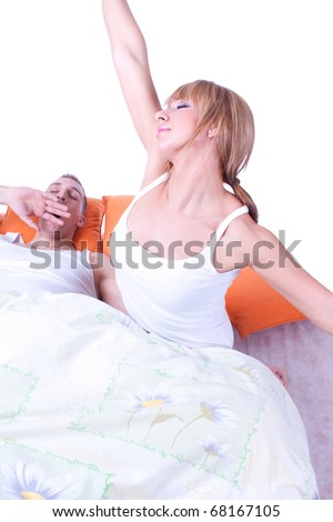Young couple had just woken up in bed together early in the morning