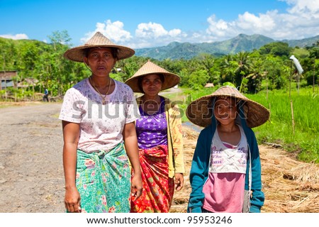 LOMBOK,INDONESIA- FEBRUARY 12: Local people after harvesting rice  on February 12,2012 in Lombok, Indonesia. Rice is more than just the staple food; it is an integral part of the Lombok culture