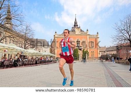 NOVI SAD, SERBIA - MAR 25: An unidentified runner on the street during the Novi Sad spring Marathon on Mar 25, 2012 in Novi Sad, Serbia
