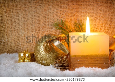 Christmas golden decoration and advent candle.