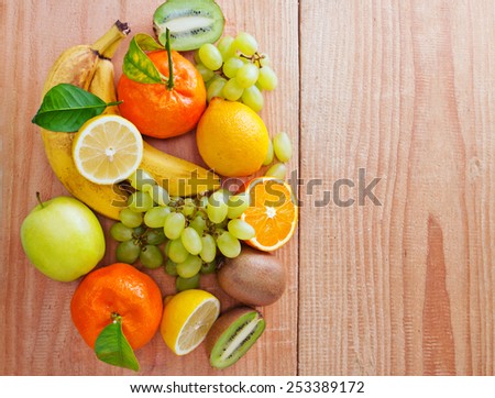 Fresh fruits isolated on wooden background.