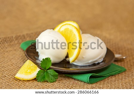 Ice cream with lemon  isolated on brown cloth  background.