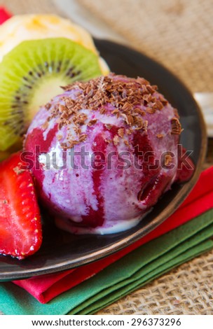 Ice cream with strawberry  isolated on brown cloth  background.Mixed fruit ice.