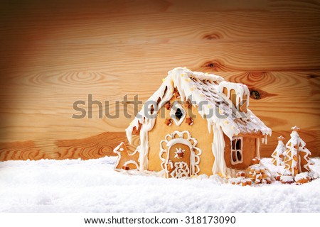 Gingerbread house on the wooden background.Christmas background.