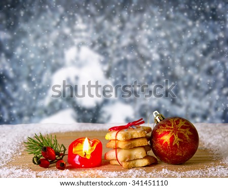 Advent candle and Christmas ball.Christmas homemade gingerbread cookies and Advent candle isolated on winter background.