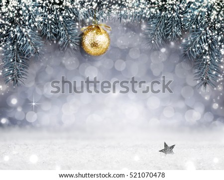 Christmas background with snow and golden ball on spruce branch.