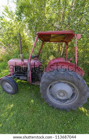 Old rusty red vintage tractor