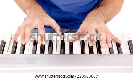 handsome young man playing the piano isolated in white background