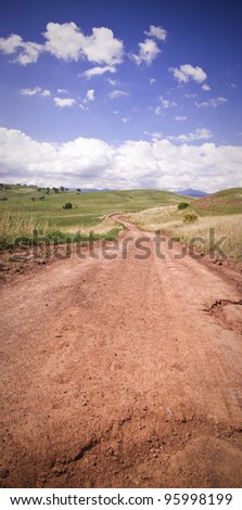 A stock photo of a red dirt road in outback Australia. Vertical panorama of multiple 12mp images.