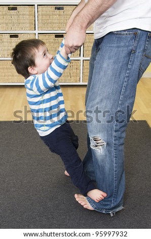 Toddler walks on Dad\'s feet