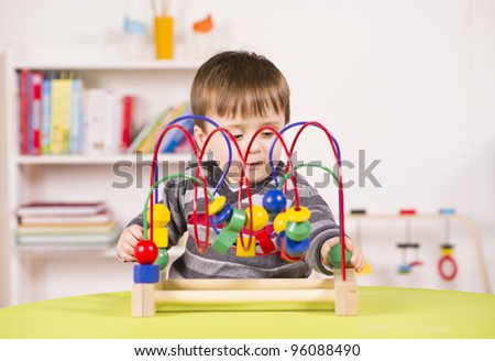 A stock photo of a child playing with a challenging toy in the play room