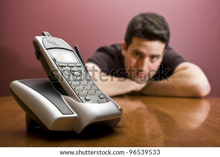 A man waits for the phone to ring