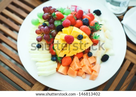 Fruit mix - fresh fruit salad with raspberries and strawberries