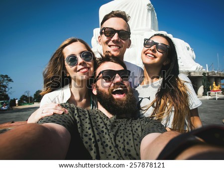 Multiracial group of young hipster friends make selfie photo with smartphone camera while traveling across Asia on summer vacation