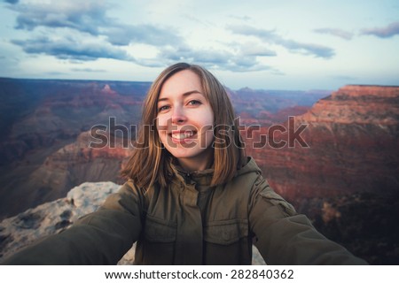 Travel hiking selfie photo of young beautiful teenager student at Grand Canyon viewpoint in Arizona, USA