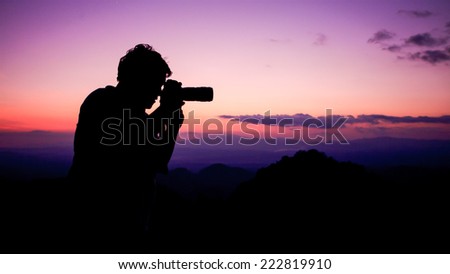 Man take a photograph during sunset.