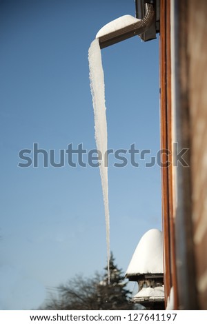 large icicle hanging down from the roof