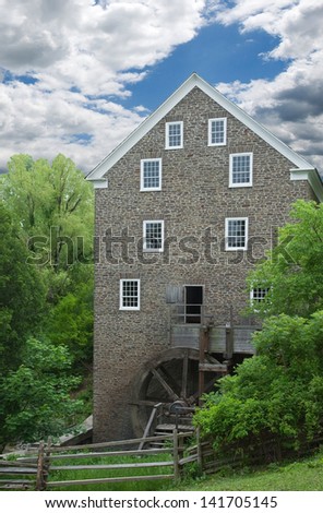 old stone building powered the flour mill entirely by wooden overshot water wheel in canada
