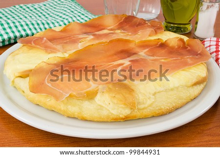 Italian pizza with ham and smoked cheese