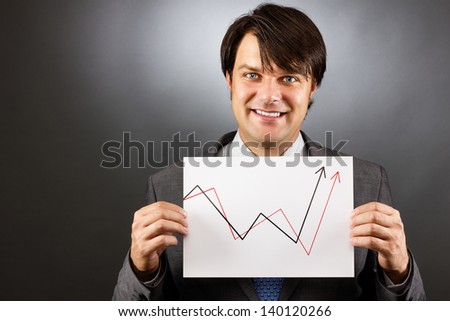 Businessman showing a rising graph, representing business growth on gray background