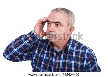 Portrait of senior man with hand at forehead thinking hard over white background