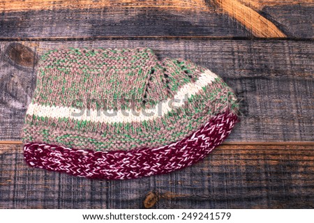 Traditional knitted slipper on wooden board