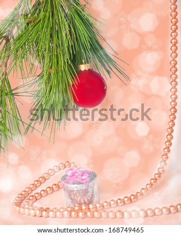 Red ball and necklace New year postcard with blurry peach background