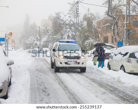 JERUSALEM - FEBRUARY 20: Police car patrolling the streets in the residential area of Jerusalem during a massive snowfall in Jerusalem on February 20, 2015