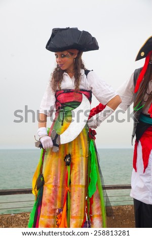 TEL AVIV - MARCH 16: Female stilt walker dressed as a pirate posing during Purim celebrations in Tel Aviv on March 16, 2014. Purim is a Jewish holiday usually celebrated at costume parties and cookies