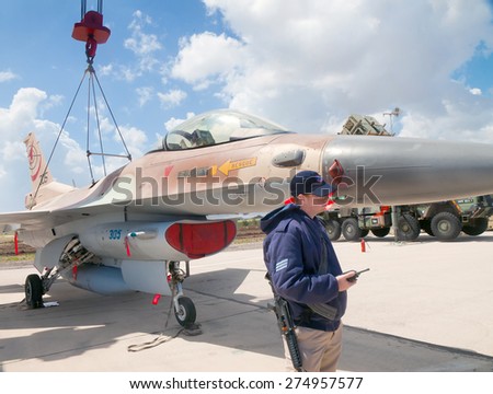 RAMAT DAVID, ISRAEL - APRIL 23: F-16 fighter attended by a crew member at the exhibition for Israeli Independence Day on April 23, 2015