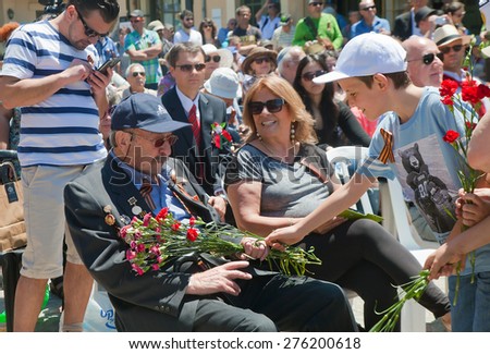 TEL AVIV - May 08: Little boy brings flowers to World War II veteran during celebration of WWII Victory Day on May 08, 2015