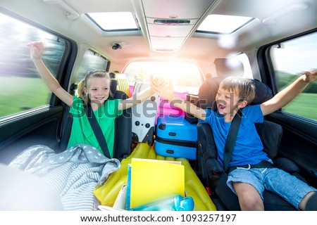 Holidays - Children relax in the car during a long car journey