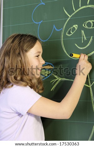 a schoolgirl in a classroom in front of the blackboard