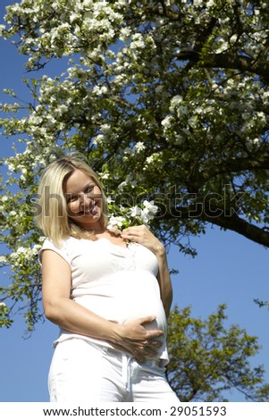 young pregnant woman enjoys nature