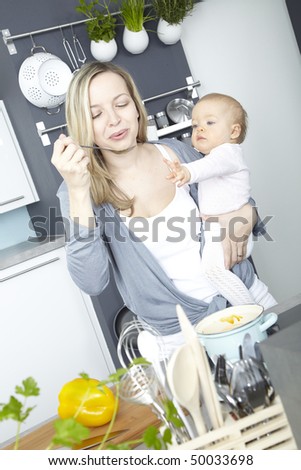 a young mother cooks with her daughter