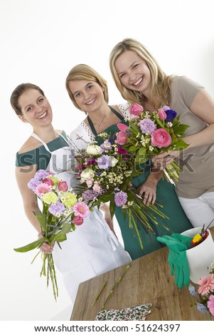 three women with bouquet of flowers