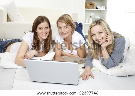friends lie on the ground with notebook computer